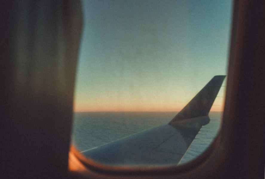 white plane wing during golden hour